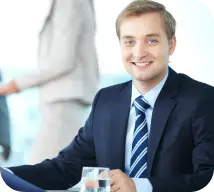 Man in office in a happy mode wearing blue coat